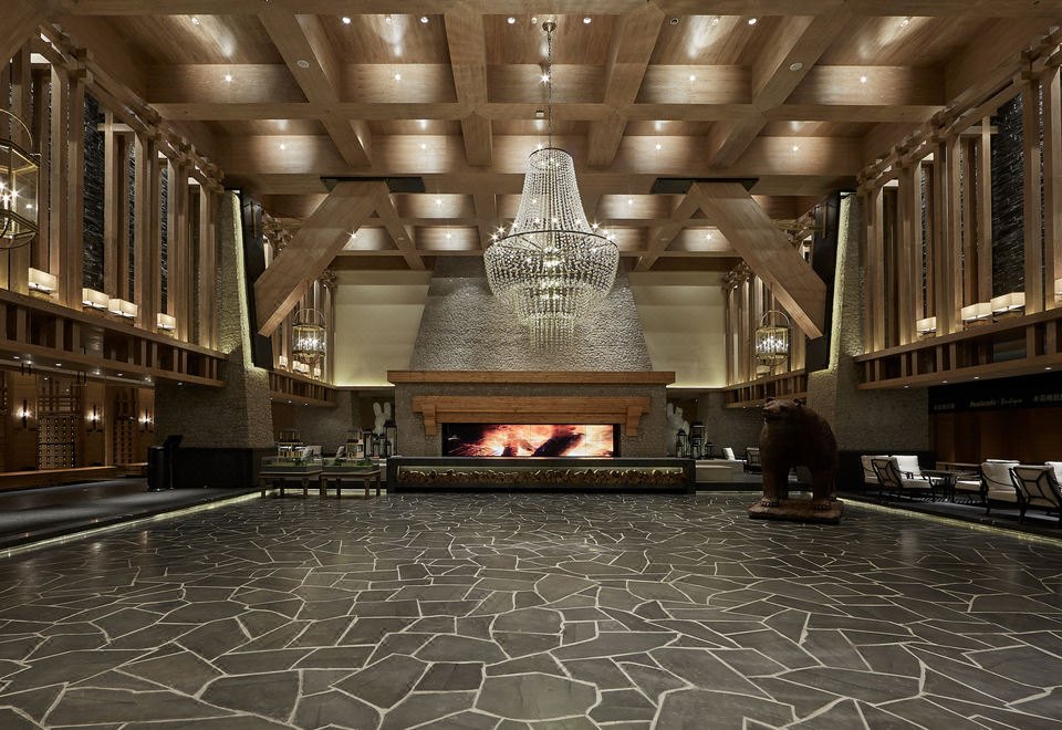 Hotel lobby with stone floor and fireplace